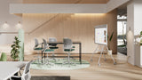 An image of an open office space. There is a table along with five chairs in the middle of the room. Logitech Rally Board 65 is in front of the table, mounted to a cart.
